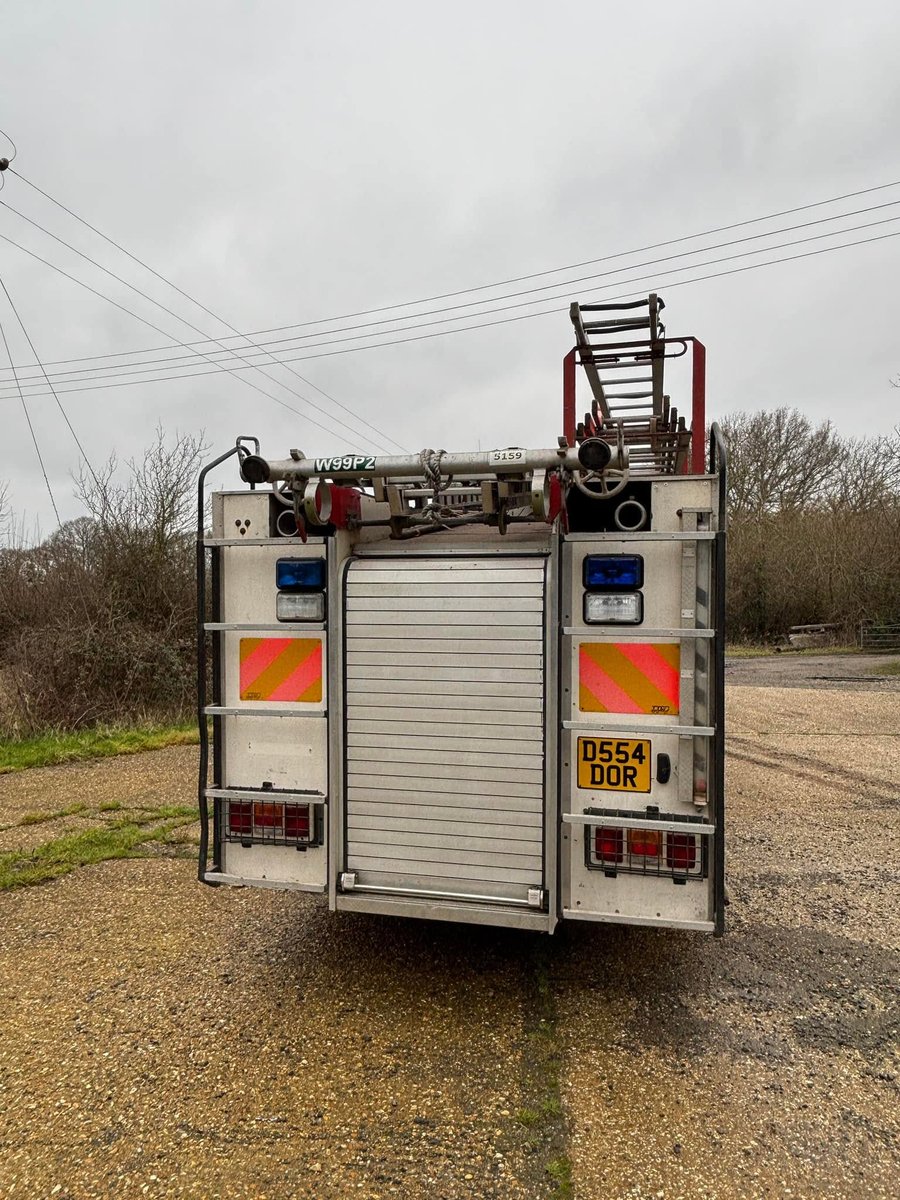Rear of the Dennis fire engine with roller shutter, ladders and rear lights