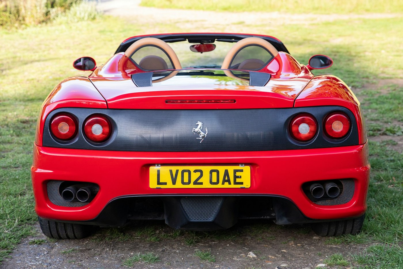 Rear of the Ferrari 360 Spider showing the carbon-backed panel and quad exhausts