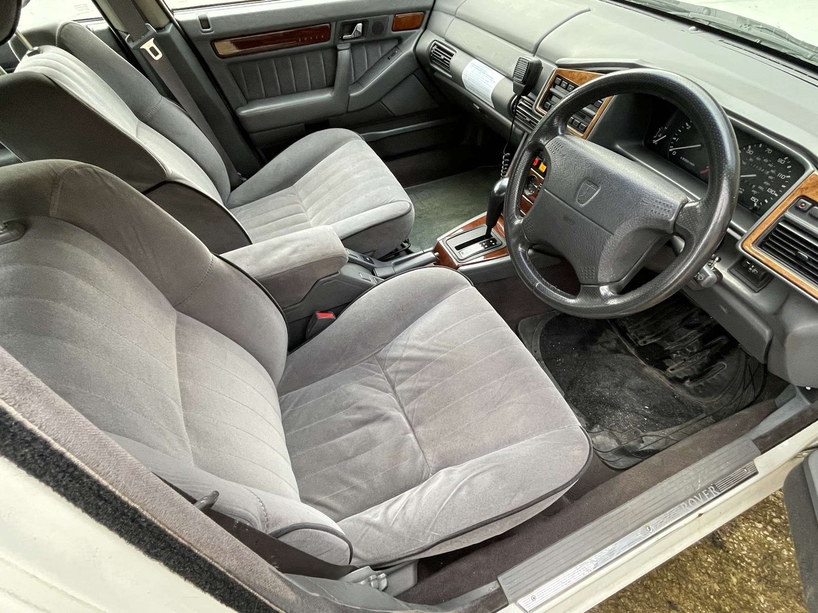 Front interior of the Rover police car with period radio, controls and grey velour