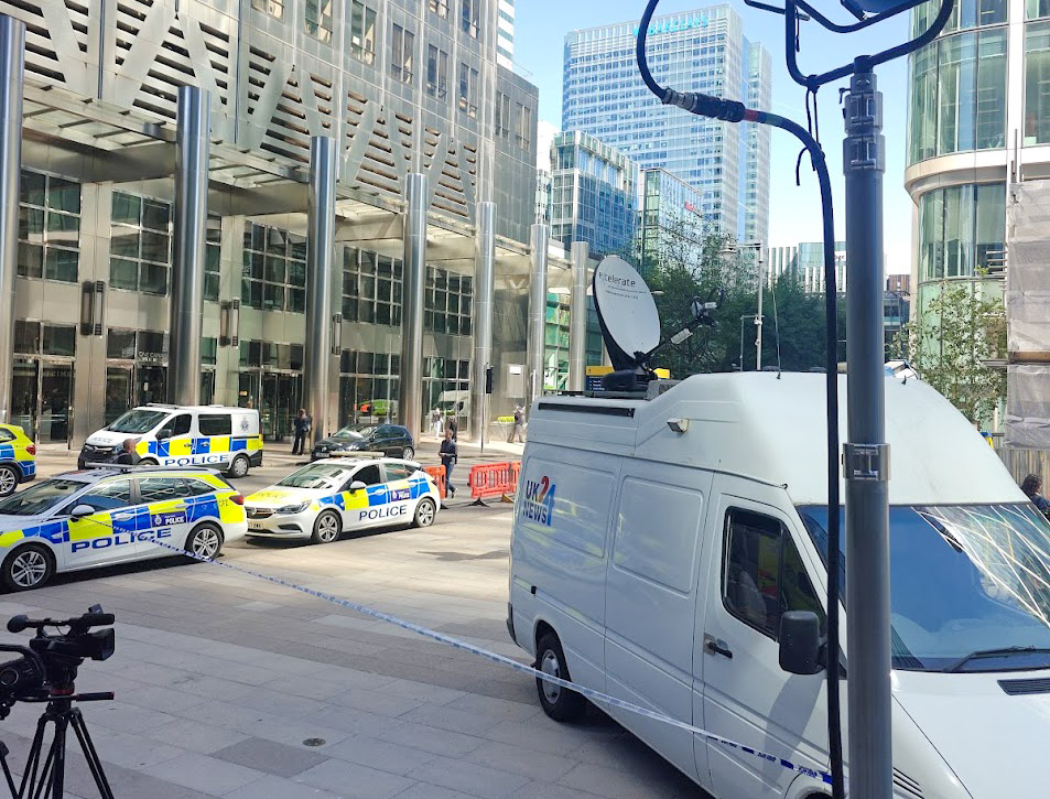 Police vehicles and broadcast unit on location at a production