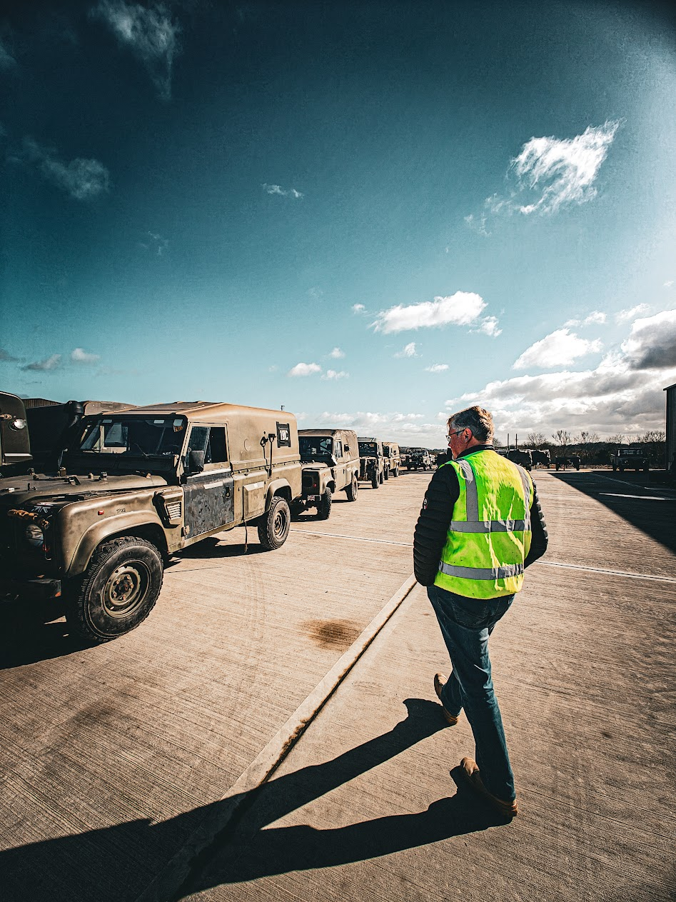 Fleet of military Land Rovers being managed on site